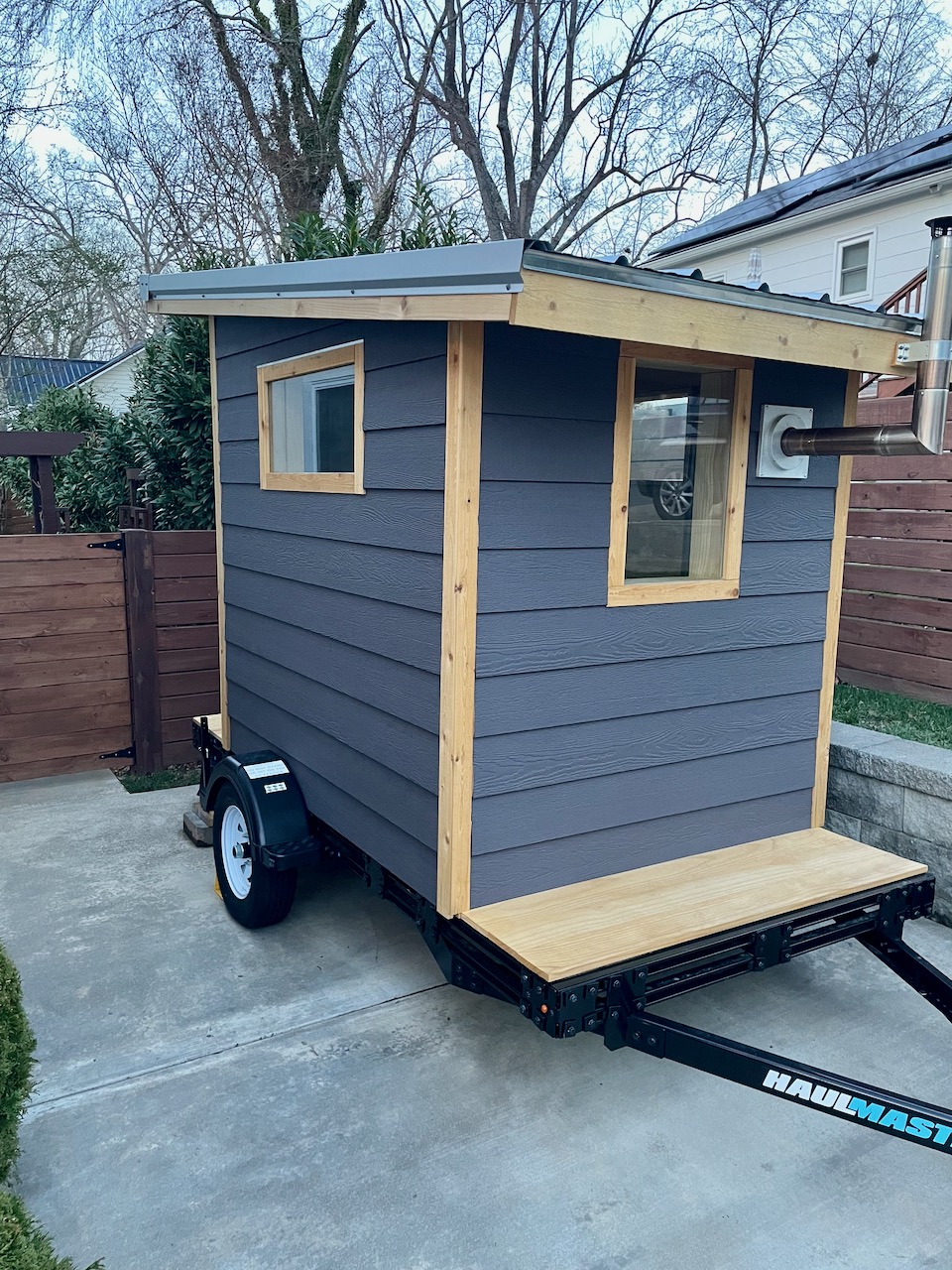 Side view of the Bushlot Sauna Club mobile sauna on 5x10 utility trailer